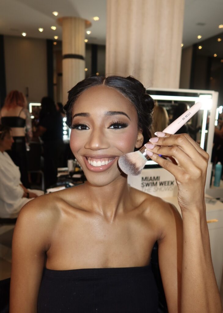 Backstage Miami Swim Week model with professional makeup brush Backstage Miami Swim Week model with professional makeup brush